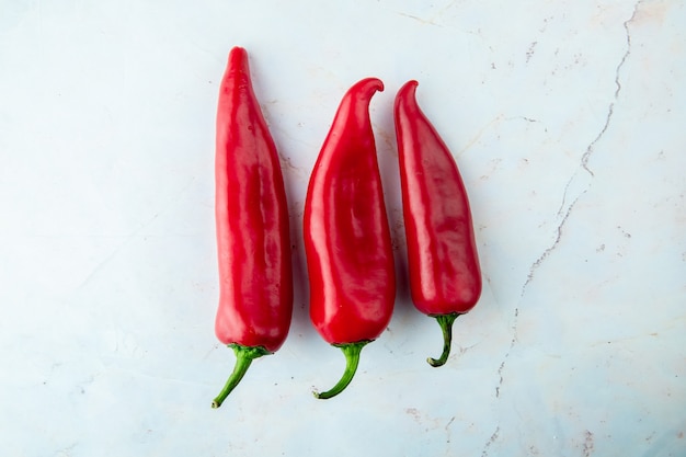 red peppers on white table