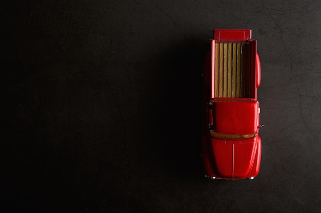 Red pickup model on the black floor