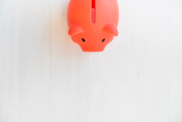 Free photo red piggy bank on white table