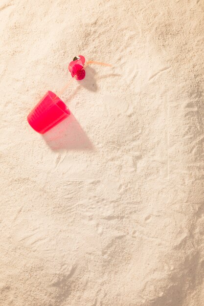 Red plastic cup on beach