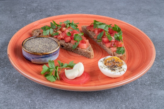 A red plate with boiled egg and toasts . High quality photo