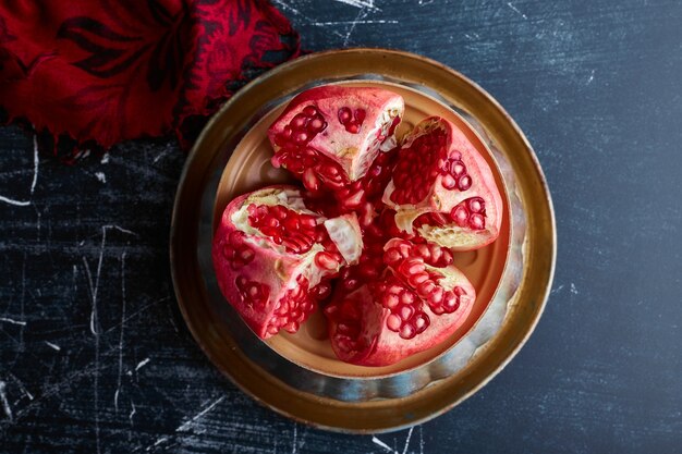 Red pomegranate cut into four pieces. 