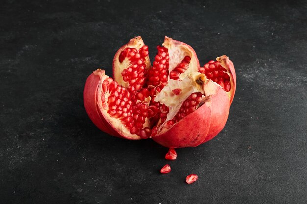 A red pomegranate torn into pieces. 