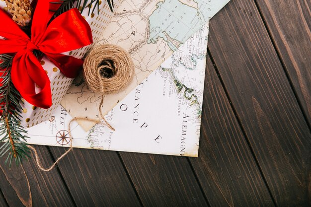 Red present box and a rope stand on white map