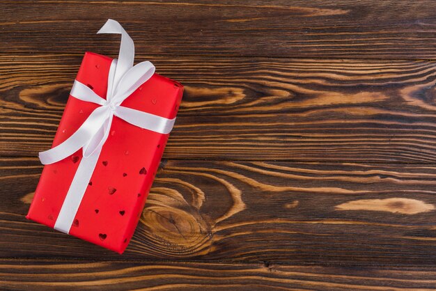 Red present box with white ribbon