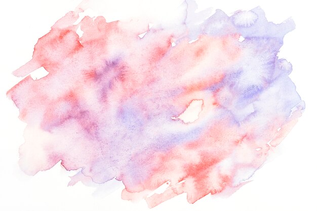 Red and purple watercolor stain on white paper