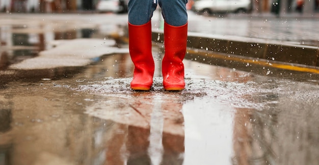 Free photo red rain boots on the street