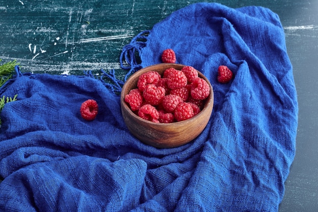 Red raspberries in a wooden bowl. 