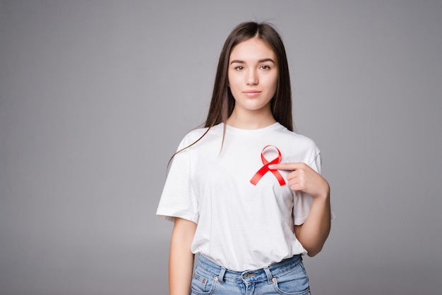 Red ribbon breast cancer of a woman isolated on gray wall
