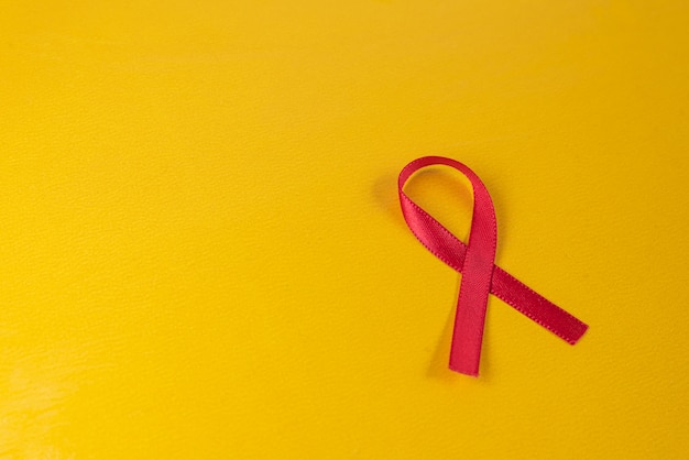 Red ribbon on yellow table