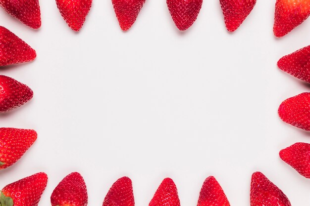 Red ripe strawberries in frame on white background 