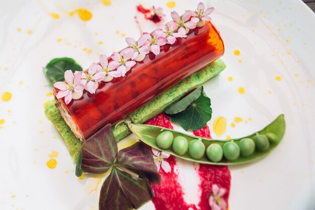 Red roll and green beans served on white plate