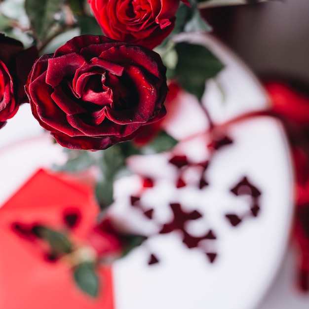 Red rose branch on table 