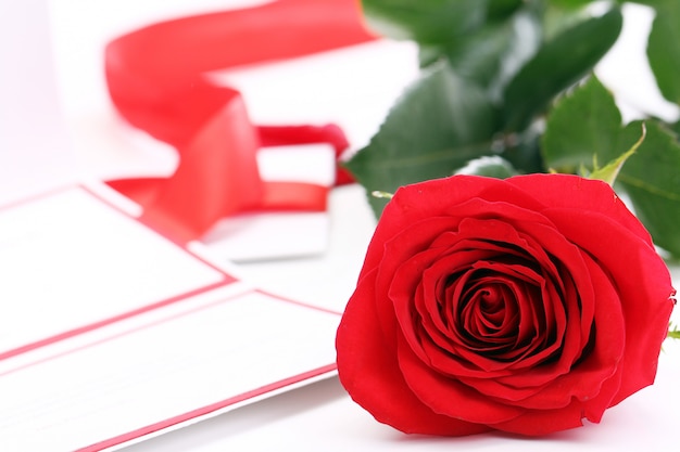 Red rose and holiday envelope