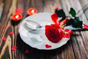 Free photo red rose on plate
