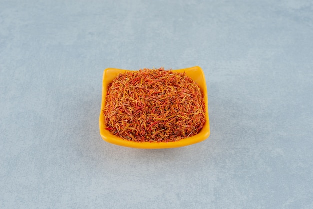 Free photo red saffron seeds in a yellow cup . high quality photo