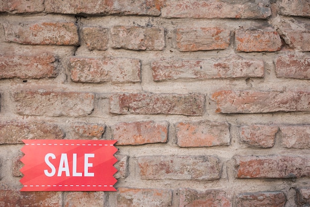 Red sale tablet on brick wall