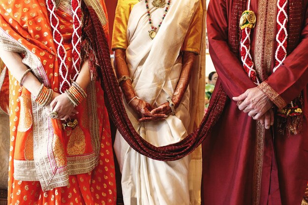 Red shawl connects bride's parents dressed for Indian wedding