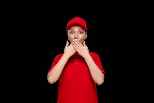 Бесплатное фото Девушка в красной рубашке, показывающая жест молчания в красной кепке, рубашке и яркой помаде