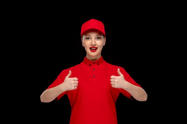 Red shirt day happy girl showing good gesture in a red cap wearing shirt with lipstick