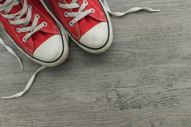 Red shoes on wooden surface