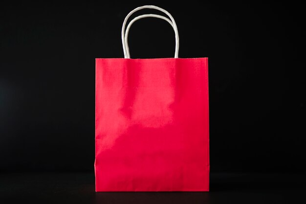 Red shopping bag on black table