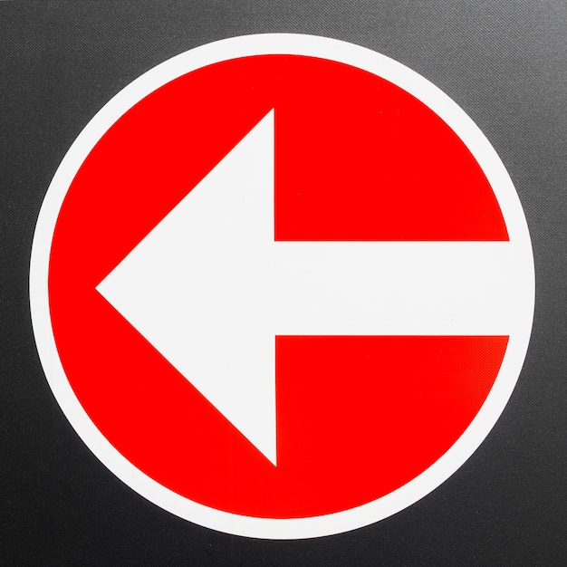 Red sign with arrow pointing left