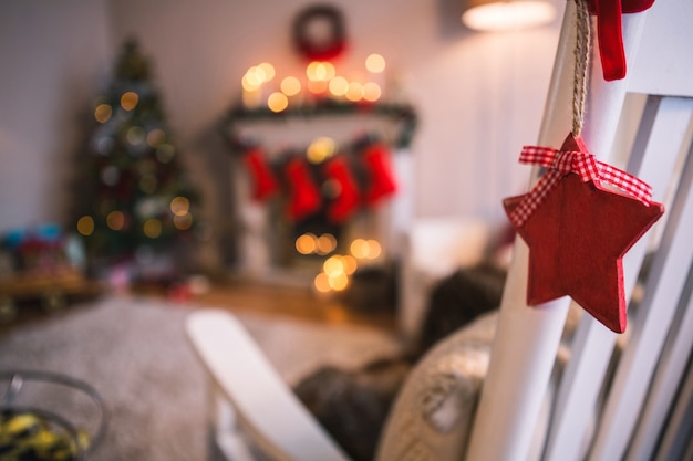 Free photo red stars hanging from a white armchair