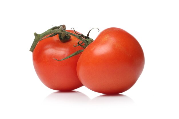 Red tomatoes on a white surface