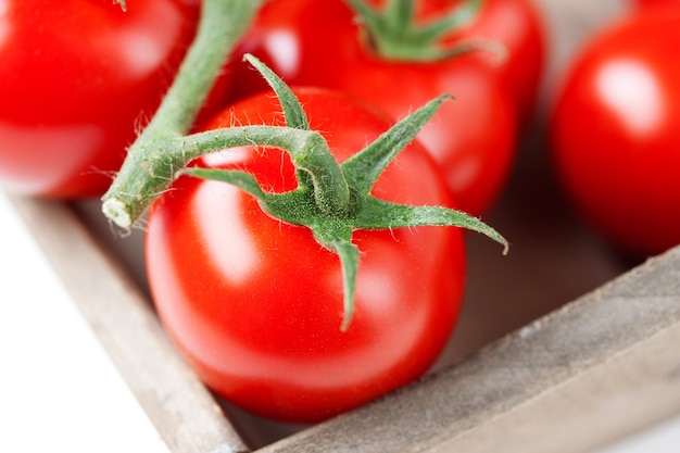 Red tomatoes with green stems