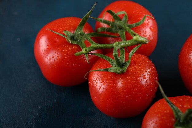 Red tomatoes with water drops on them. Top view.