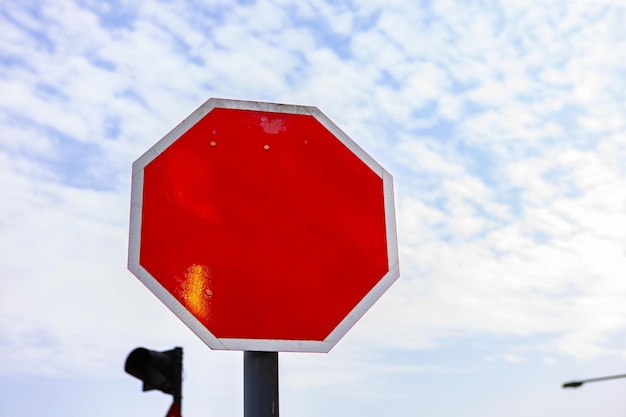 Red traffic sign with copy space against blue sky