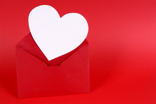 Red valentine envelope with a white heart