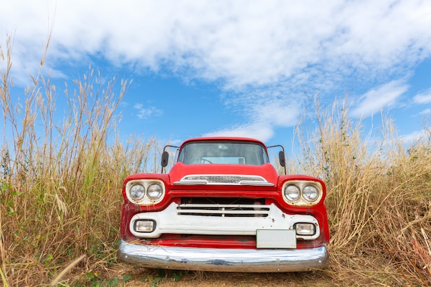 Red vintage car with blue sky