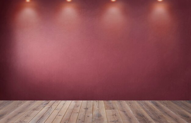 Red wall with a row of spotlights in an empty room