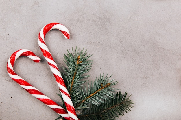 Red white candies and fir branch lie on the floor