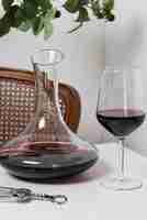 Free photo red wine carafe and glass on table