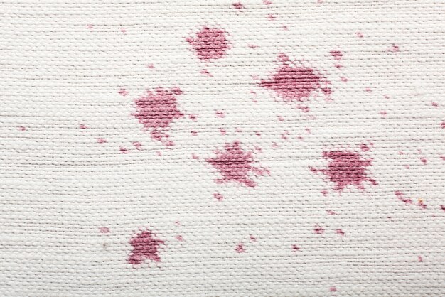 Red wine stains on white material