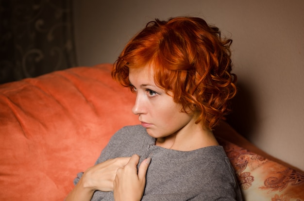 Free photo red woman on a sofa