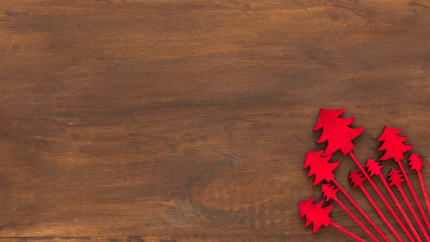 Red wooden Christmas trees on table 