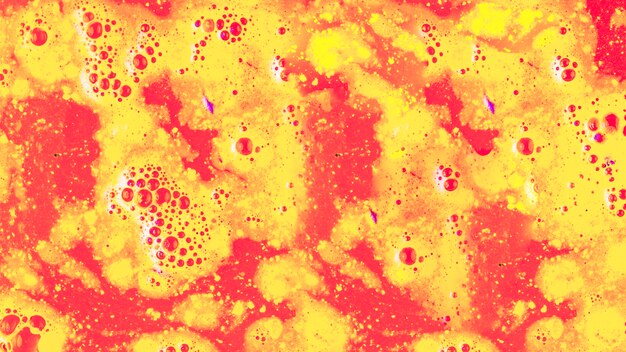 Red and yellow bath bomb in the bath water