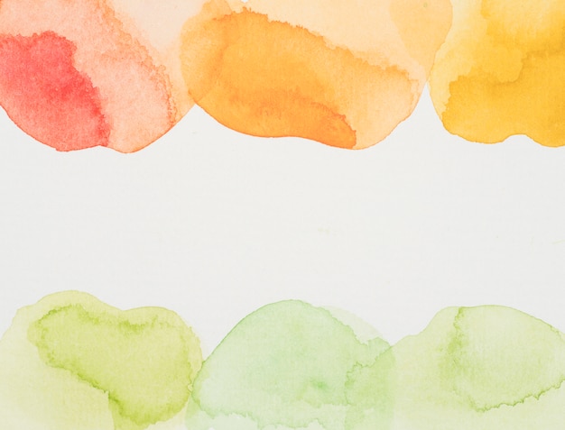 Red, yellow and green paints on white paper