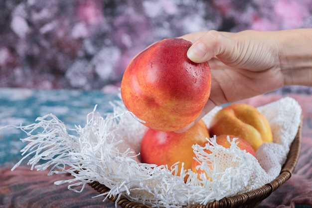 Red yellow peach isolated on a piece of white towel.