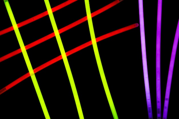 Red; yellow and purple neon tubes on black background