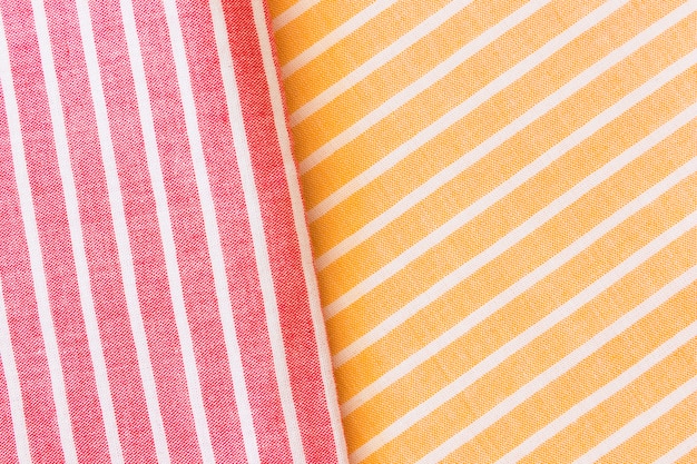 Free photo red and yellow realistic folded linen texture fabric