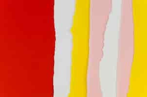 Free photo red and yellow vertical torn papers