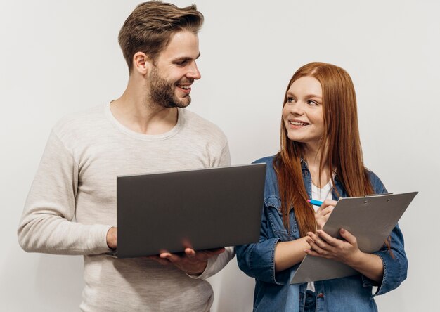 Redhead businesswoman working on a laptop with her coworker