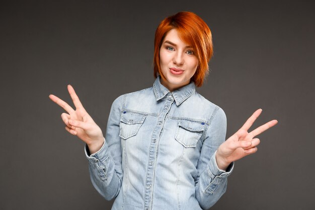 Redhead cute woman show peace sign