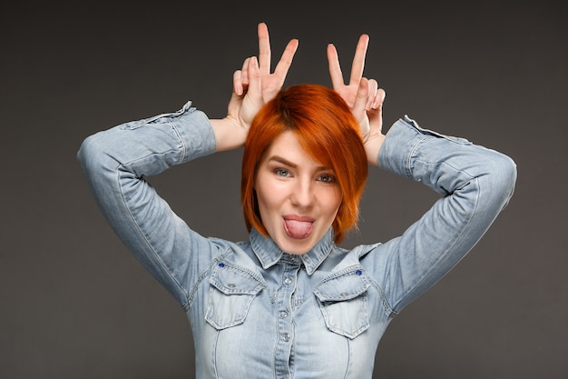 Redhead cute woman show peace sign