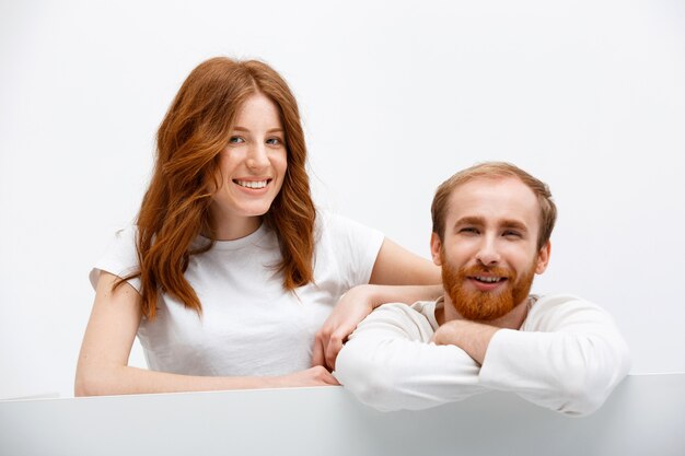 Redhead funny couple lean on table